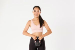 Sport, wellbeing and active lifestyle concept. Smiling strong and slim asian fitness girl